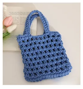 Close-up of the dark blue hollow woven cotton tote bag with intricate geometric net texture