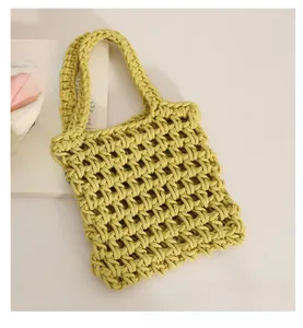 Close-up of lime green woven tote bag with hollow grid mesh and matching handle