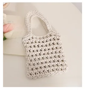 Detail of off-white cotton rope woven tote bag with hollow texture and sturdy grain