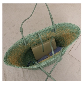 Interior view showing the large capacity and mint green straw weave of the tote bag