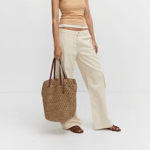 Large capacity hollow straw tote bag with brown handles for casual beach holiday style
