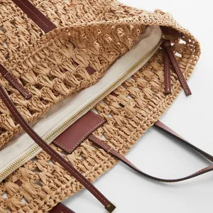 Handmade woven straw tote bag with brown leather straps and hollow crochet pattern