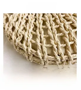 Detailed close-up showing the handcrafted straw weave texture and fabric lining of the bag
