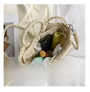 Detail view of woven straw beach bag interior capacity with drawstring closure
