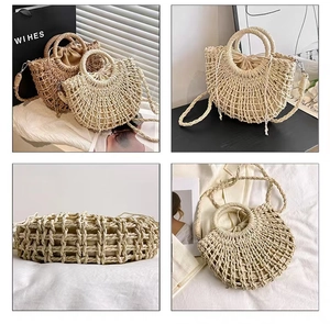 Detail view showing hollow woven straw texture and drawstring liner of the semicircle bag