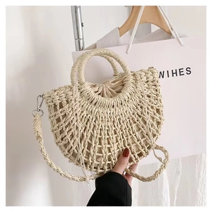 Detail of beige straw bag with hollow semi-circle weave and drawstring lining