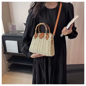 Détail du sac en paille tissé main avec anses en bambou et bandoulière en cuir