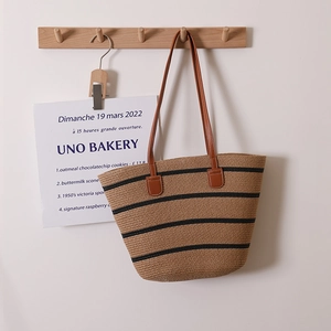 Large capacity straw woven tote bag with black stripes and brown leather shoulder straps