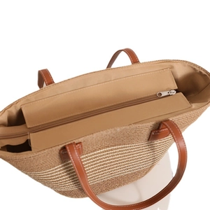 Straw tote bag with khaki and white stripes, leather handles, and a secure top zipper