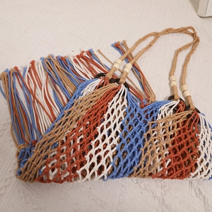 Handmade bohemian crochet beach bag with colorful fringe and wood bead handles