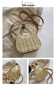 Detail of off-white woven straw bag with brown leather handle and drawstring closure