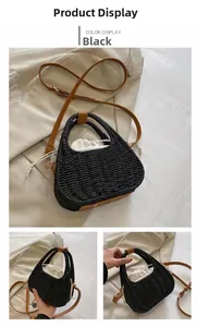 Detail of black woven straw crossbody bag with brown leather strap and inner drawstring