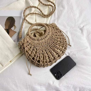 Handmade woven straw beach bag with round handles and crossbody strap for summer holidays