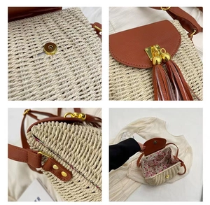 Detail of straw crossbody bag showing floral lining, magnetic buckle and leather tassels