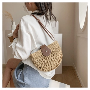 Detail of woven straw crossbody bag with brown leather flap and mesh texture