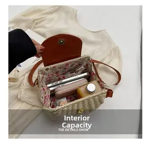 Internal capacity of straw crossbody bag showing phone, wallet and perfume details