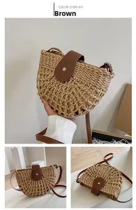 Detail of hollow woven straw bag with dark brown faux leather flap and long strap