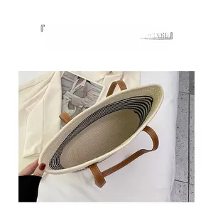 Internal view showing large capacity and black-white striped lining of the woven tote