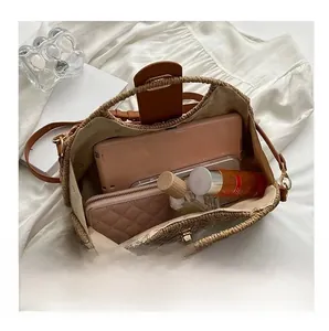 Interior view of straw tote bag showing capacity for wallet, perfume, and accessories
