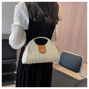 Detail of hand-woven straw bag with premium brown leather flap and metal twist lock