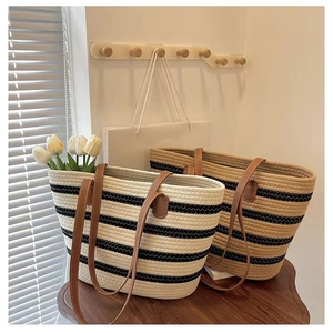 Detail of striped woven tote bags with leather handles for beach and summer vacations