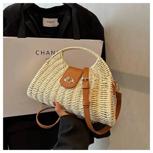 Detail of hand-woven straw bag with premium leather clasp and golden turn-lock closure
