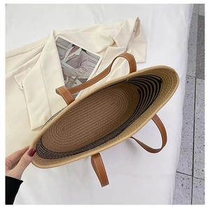 Macro view of woven cotton tote bag interior with striped pattern and faux leather handles