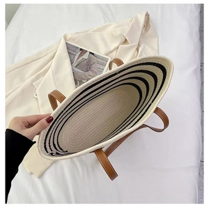Macro detail of striped cotton woven tote bag featuring brown leather handles and interior