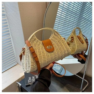 Mirror reflection showing front and back of straw crossbody bag with leather flap detail