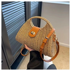 Detail of hand-woven straw bag featuring brown leather flap and gold twist lock closure