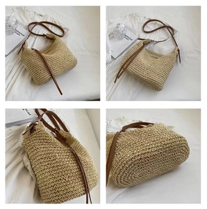 Detail view of handmade woven straw bag with thin brown leather strap for summer vacation