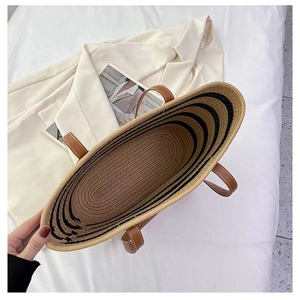 Top view of striped woven cotton tote bag with brown leather handles and large capacity