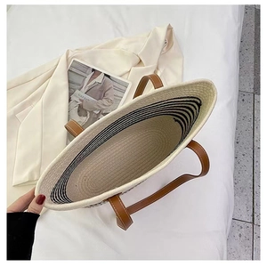 Top-down view of woven cotton tote bag showing interior stripes and brown leather straps