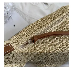 Detail of paper rope woven bag showing high-quality smooth metal zipper and brown leather puller