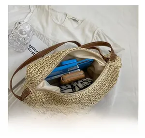 Internal view of straw woven bag showing storage for phone and wallet with zipper