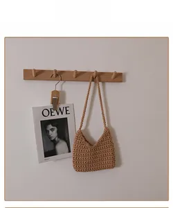Close-up of warm brown hand-woven crochet shoulder bag featuring intricate mesh texture