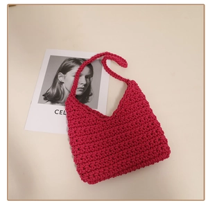 Detailed close-up of rose red hand-woven cotton rope shoulder bag with loop texture
