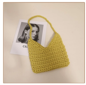 Close-up of vibrant yellow woven cotton shoulder bag with intricate chunky knit texture