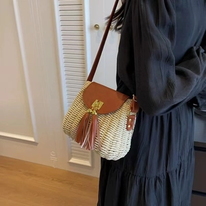 Vintage straw crossbody bag with brown leather flap and stylish long tassels for beach