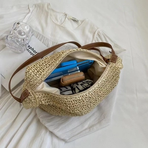 U-shaped beige paper rope woven shoulder bag with brown leather strap and roomy interior