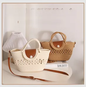 Detail of woven beach bags with leather flaps and large pearl button accents