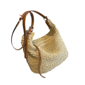 U-shaped woven paper rope shoulder bag with brown leather strap for summer beach vacations
