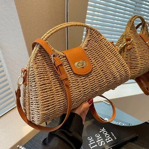 Chic half-moon straw shoulder bag with orange leather trim and golden metal clasp for beach