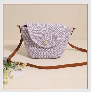 Detailed close-up of purple and white woven cotton pattern with a large pearl button accent
