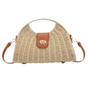 Fashionable straw woven crossbody bag with brown leather trim and golden twist lock