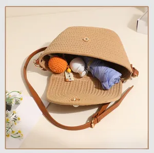 Detail of handwoven straw bag interior showing large capacity for umbrella and cosmetics
