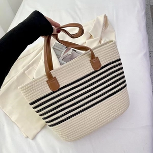 Striped woven cotton tote bag with brown leather handles for beach or casual travel
