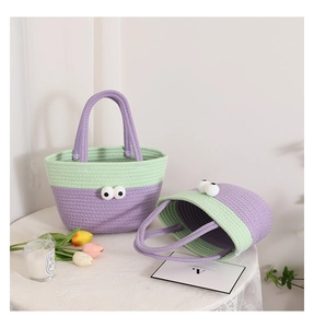 Detail of cute woven cotton storage basket with large cartoon eyes and dual-tone design