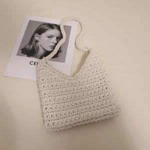 Minimalist beige woven cotton shoulder bag with tight knit texture for beach vacations