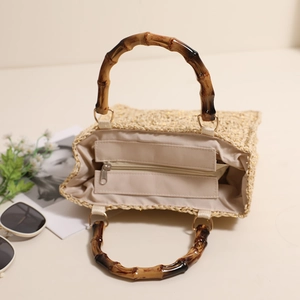 Square woven straw tote bag with retro bamboo handles and interior zipper lining